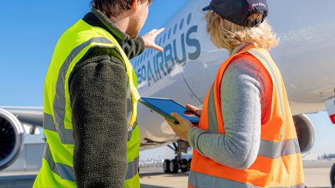 Man pointing at aircraft to lady Man pointing at aircraft to lady