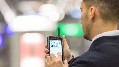Man holding a mobile device Man holding a mobile device