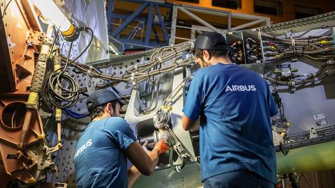 Maintenance personnel working on an aircraft component, ensuring operational safety and efficiency.