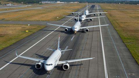 Aircrafts lined up on a runway Aircrafts lined up on a runway