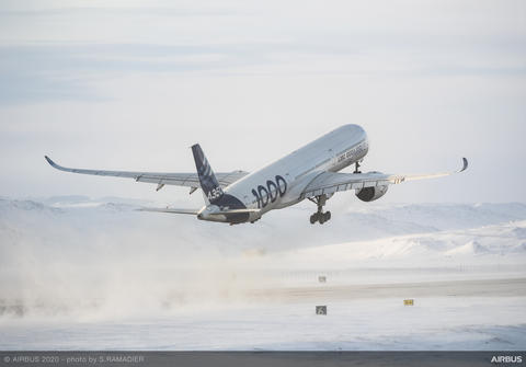 Airbus A350-1000 taking off in a snowy environment