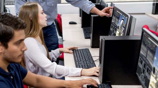 Students engaged in a maintenance training course under the guidance of an instructor in a classroom