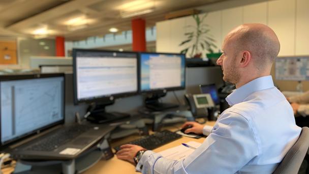 Person working in front of screens Person working in front of screens