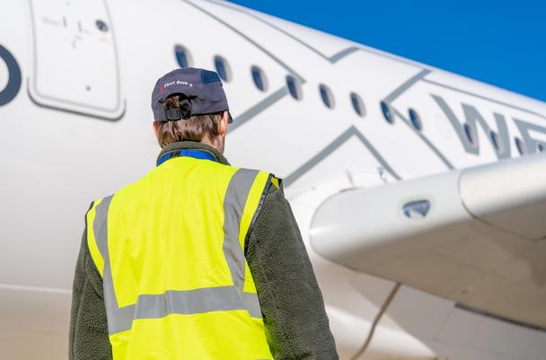 mechanic in front of an A350 mechanic in front of an A350