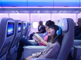 Girl listening music into the A330neo Airspace cabin