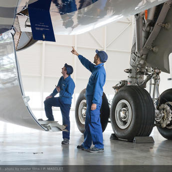 Maintenance technicians checking an aircraft to ensure operational safety.