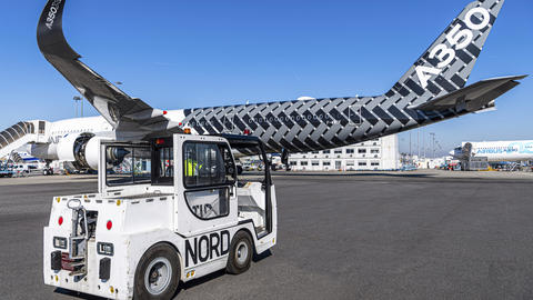 Charlatte tractor on tarmac and A350 aircraft