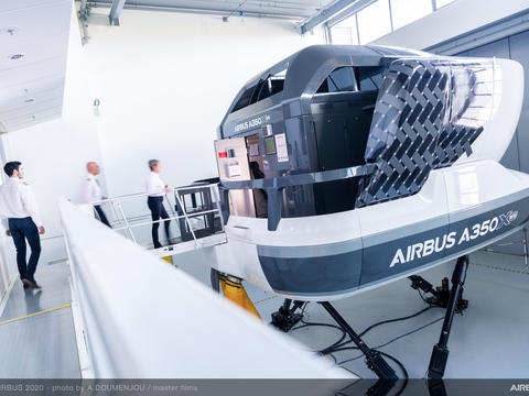 Pilot trainees stepping into a full flight simulator as part of their flight training course.
