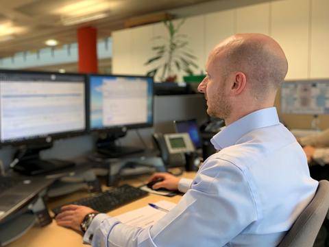 Person working in front of screens
