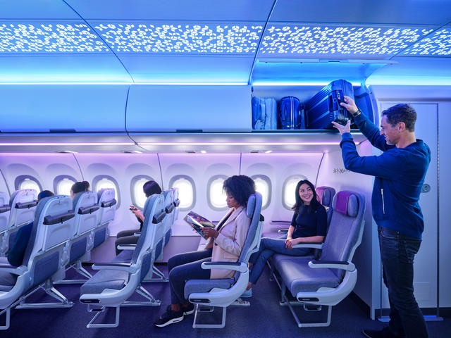 A320 Airspace Cabin - man loading lugagge to XL Bin