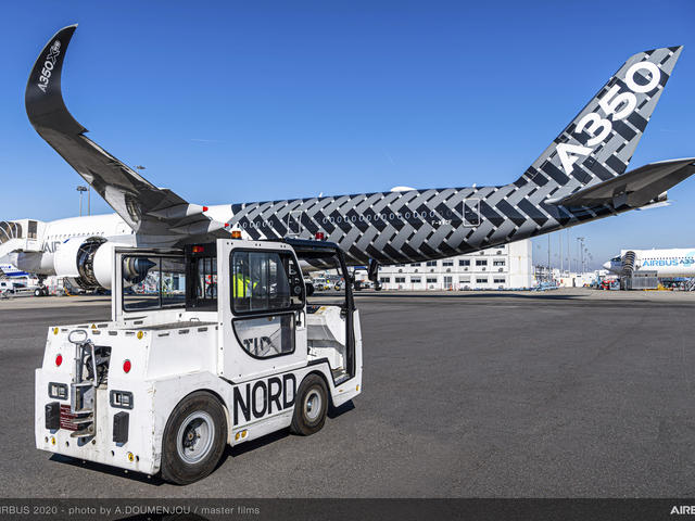 Charlatte tractor on tarmac and A350 aircraft