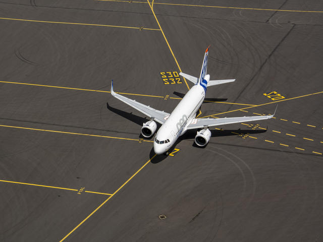 A319neo on the tarmac, ready for takeoff.