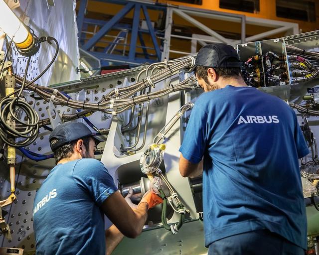 Maintenance personnel working on an aircraft component, ensuring operational safety and efficiency.
