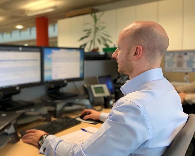 Person working in front of screens Person working in front of screens