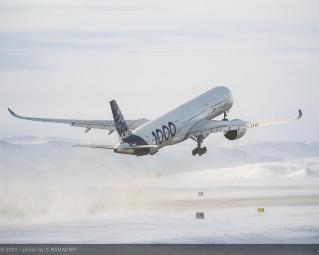 Airbus A350-1000 taking off in a snowy environment