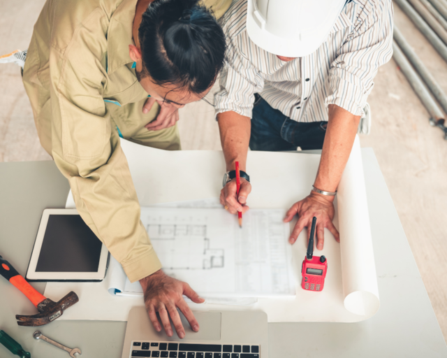 People working on a blueprint People working on a blueprint