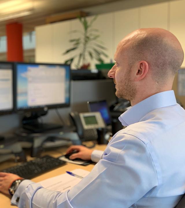 Person working in front of screens
