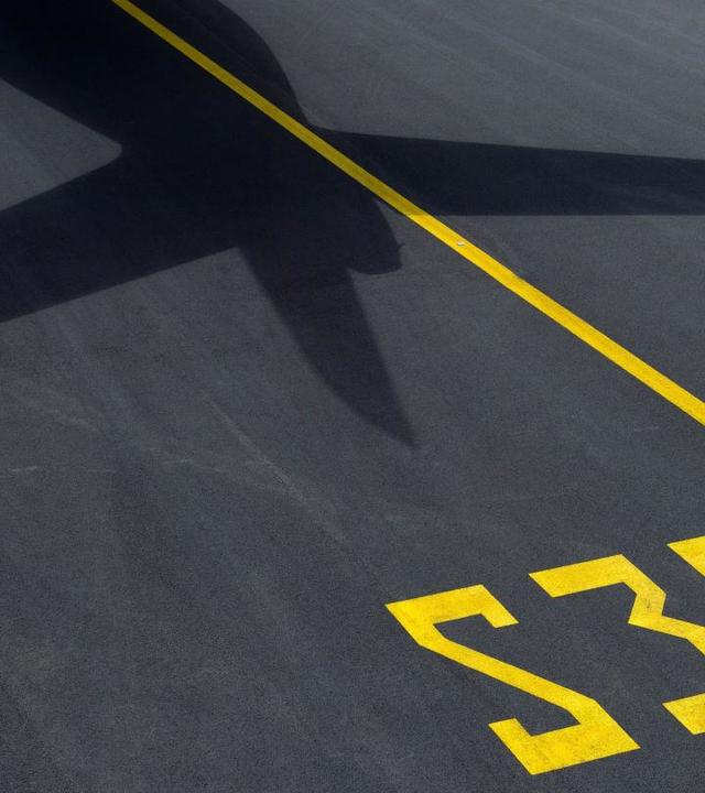 shadow of an aircraft's tail on the runway