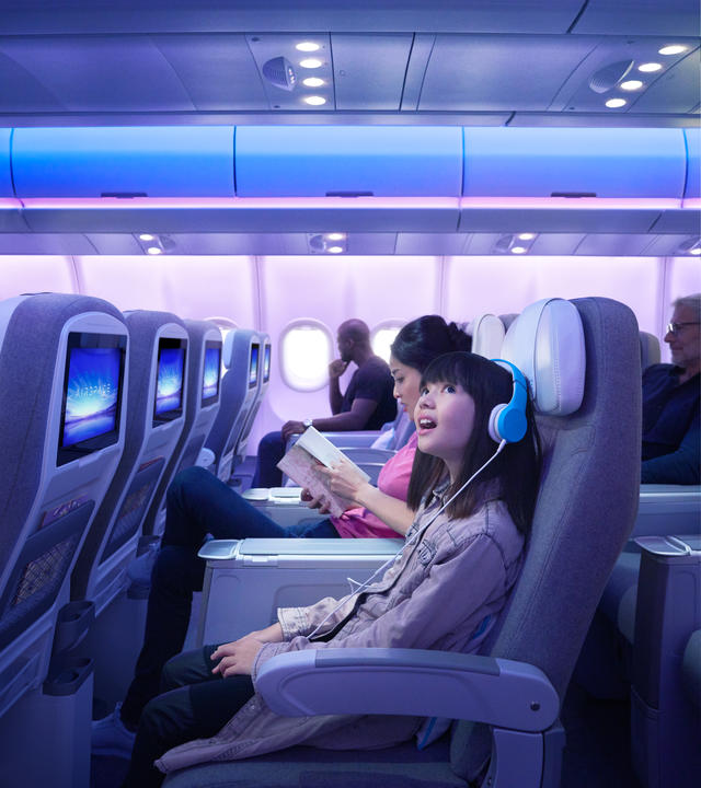Girl listening music into the A330neo Airspace cabin