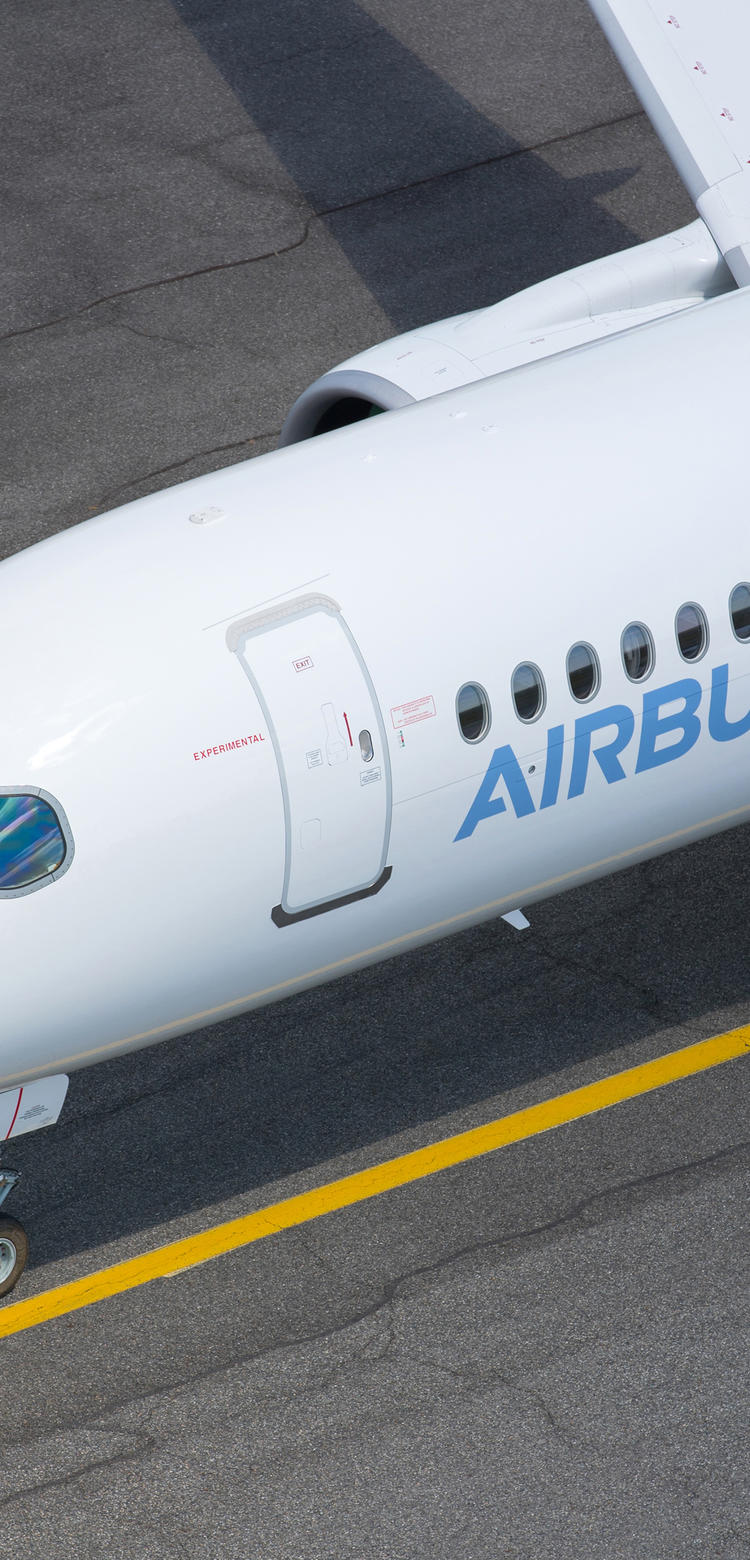 A220-300 aircraft preparing for takeoff on the runway