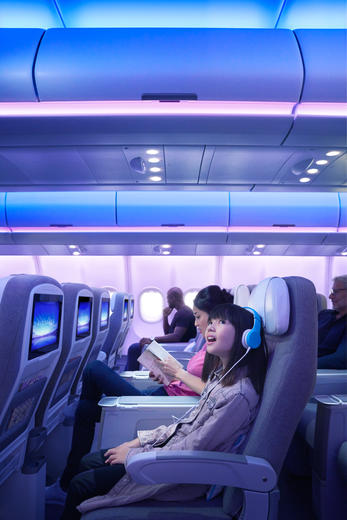 Girl listening music into the A330neo Airspace cabin